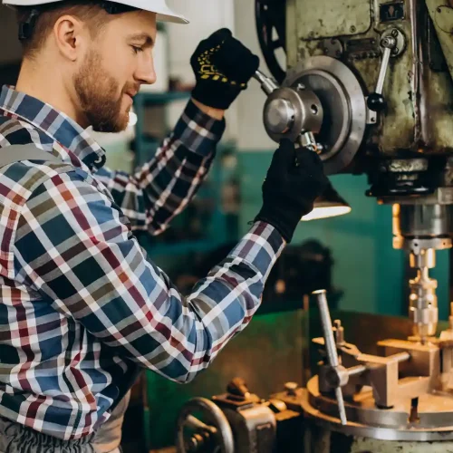 workman-wearing-hard-hat-working-with-metal-constructions-factory